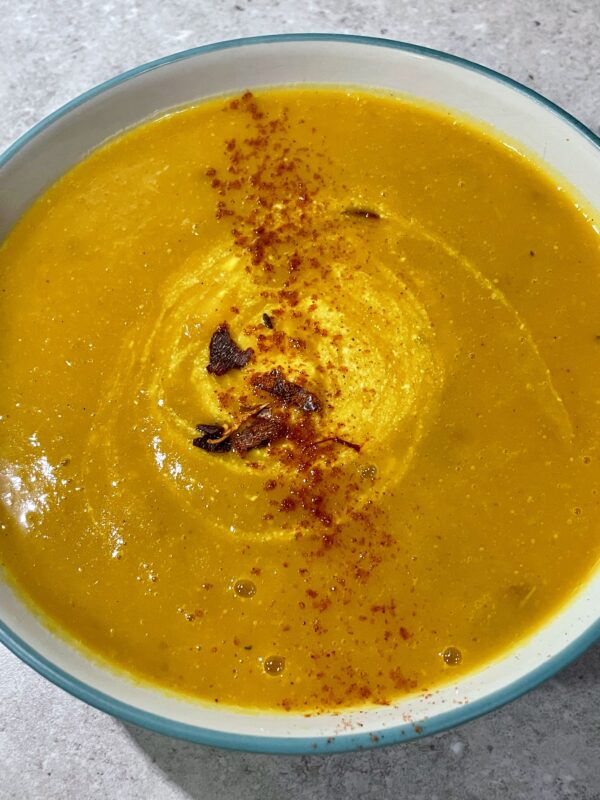 Roasted Kabocha Squash Soup (vegan & gf) shown with greek natural yogurt and a sprinkle of chilli & cayenne pepper