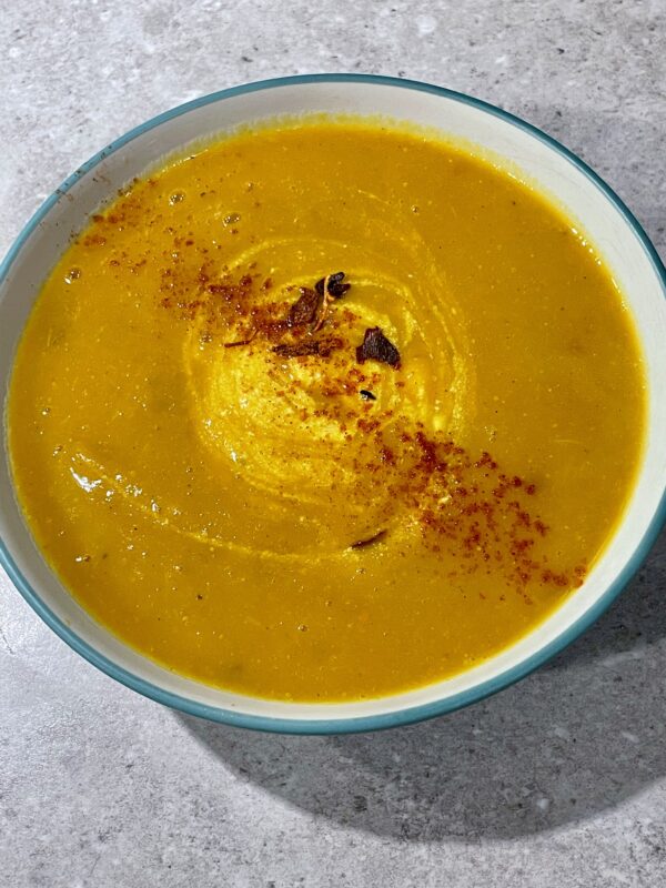 Roasted Kabocha Squash Soup (vegan & gf) shown with greek natural yogurt and a sprinkle of chilli & cayenne pepper