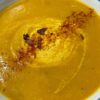 Roasted Kabocha Squash Soup (vegan & gf) shown with greek natural yogurt and a sprinkle of chilli & cayenne pepper