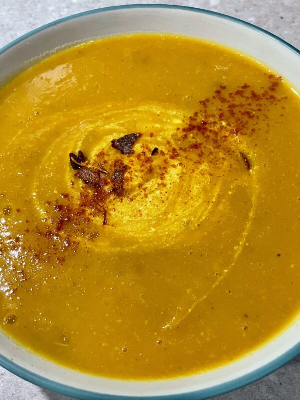 Roasted Kabocha Squash Soup (vegan & gf) shown with greek natural yogurt and a sprinkle of chilli & cayenne pepper